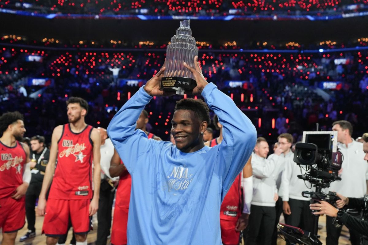 Anthony Edwards holding up the All-Star games’ MVP Trophy (royaltyfreepics).