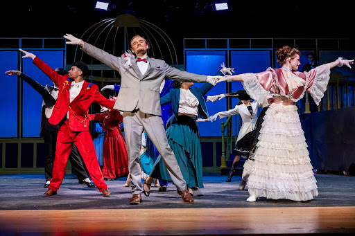 Benjamin Borski playing the role of Professor Higgins dancing with Madeline Hansen playing as Eliza Doolittle in the front center (Benjamin Borski).
